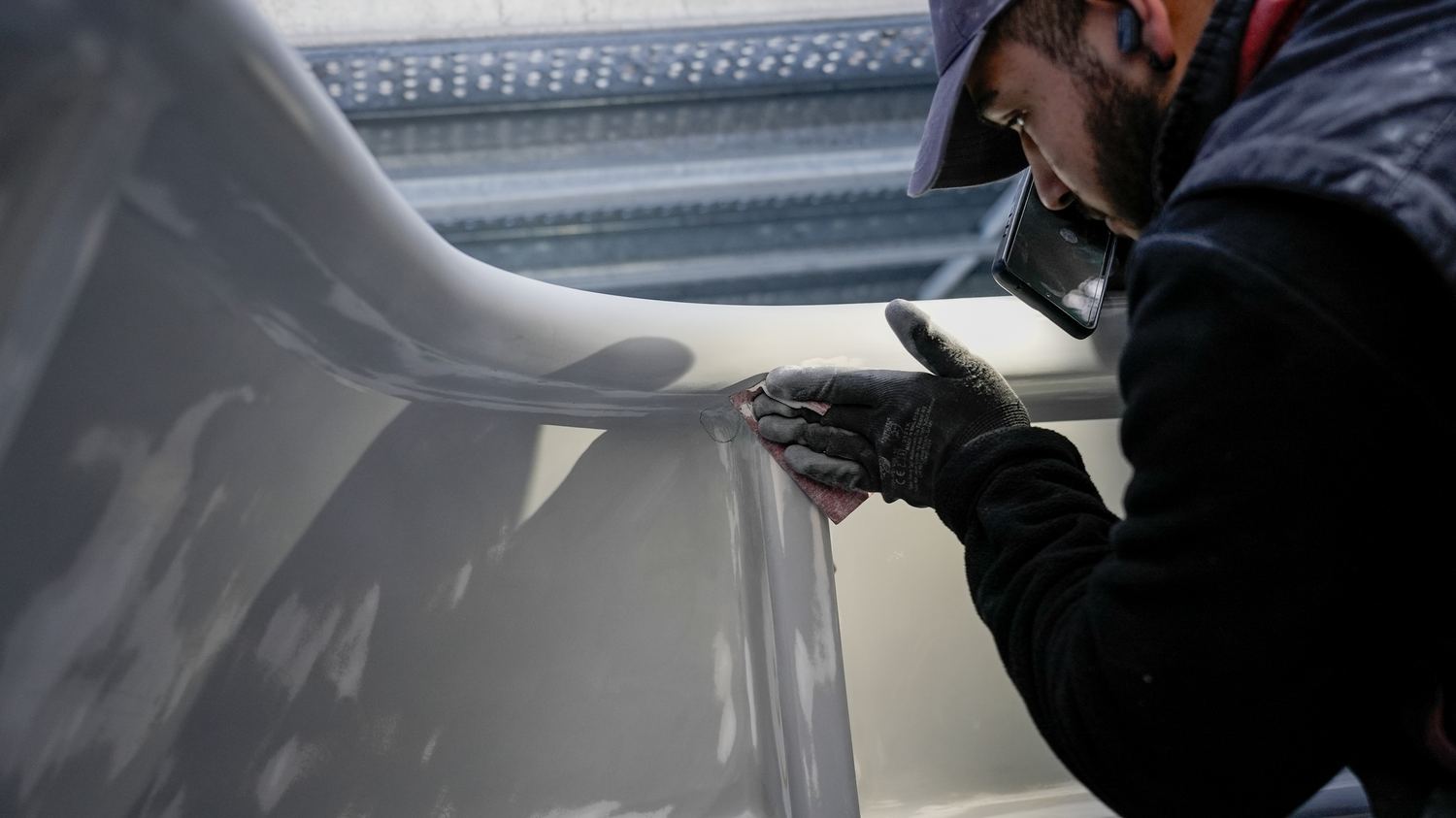 A painter working a surface under cover