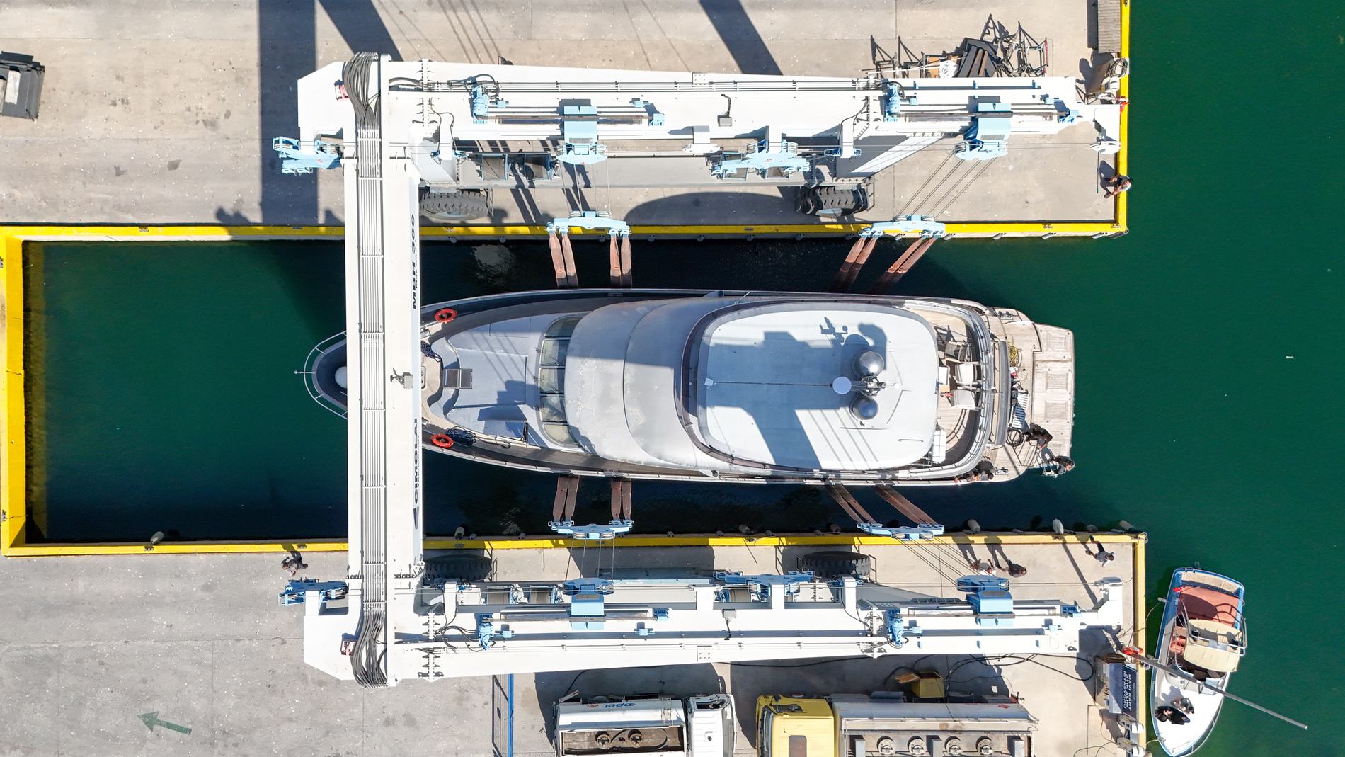 Motor yacht positioned in a travel lift beside the quay in Tuzla
