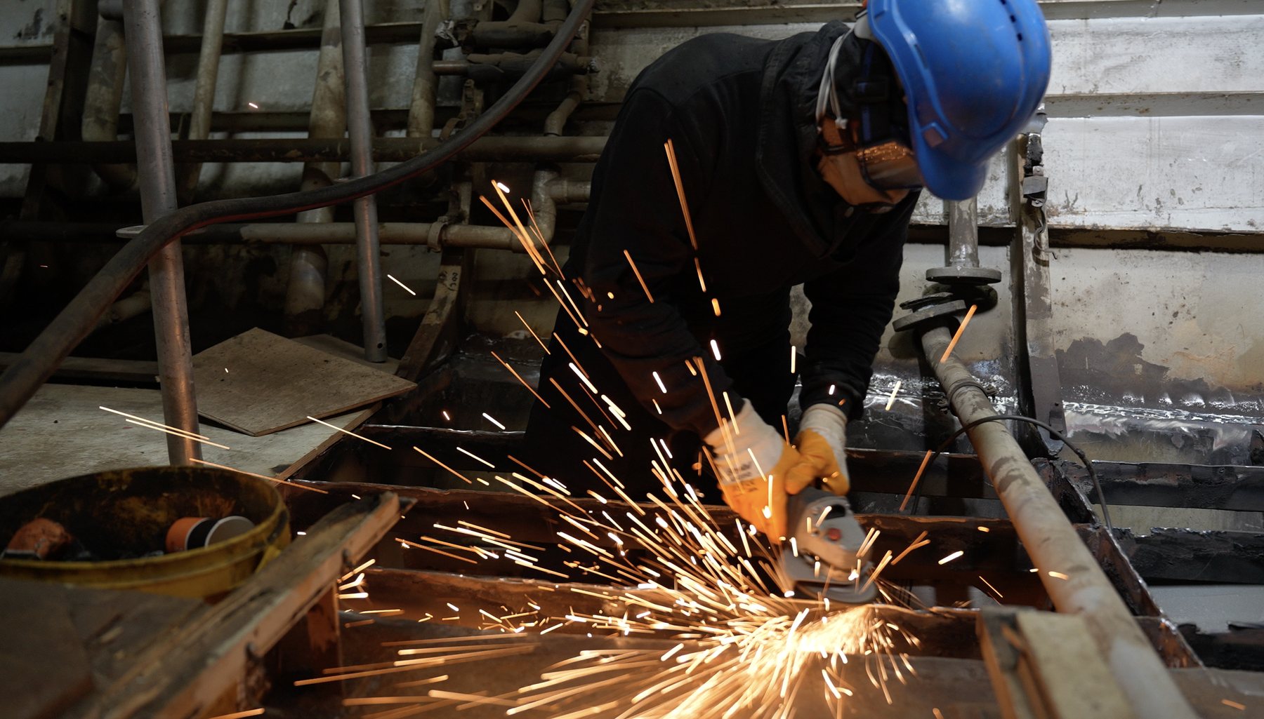 Specialist welding steel during a yacht refit