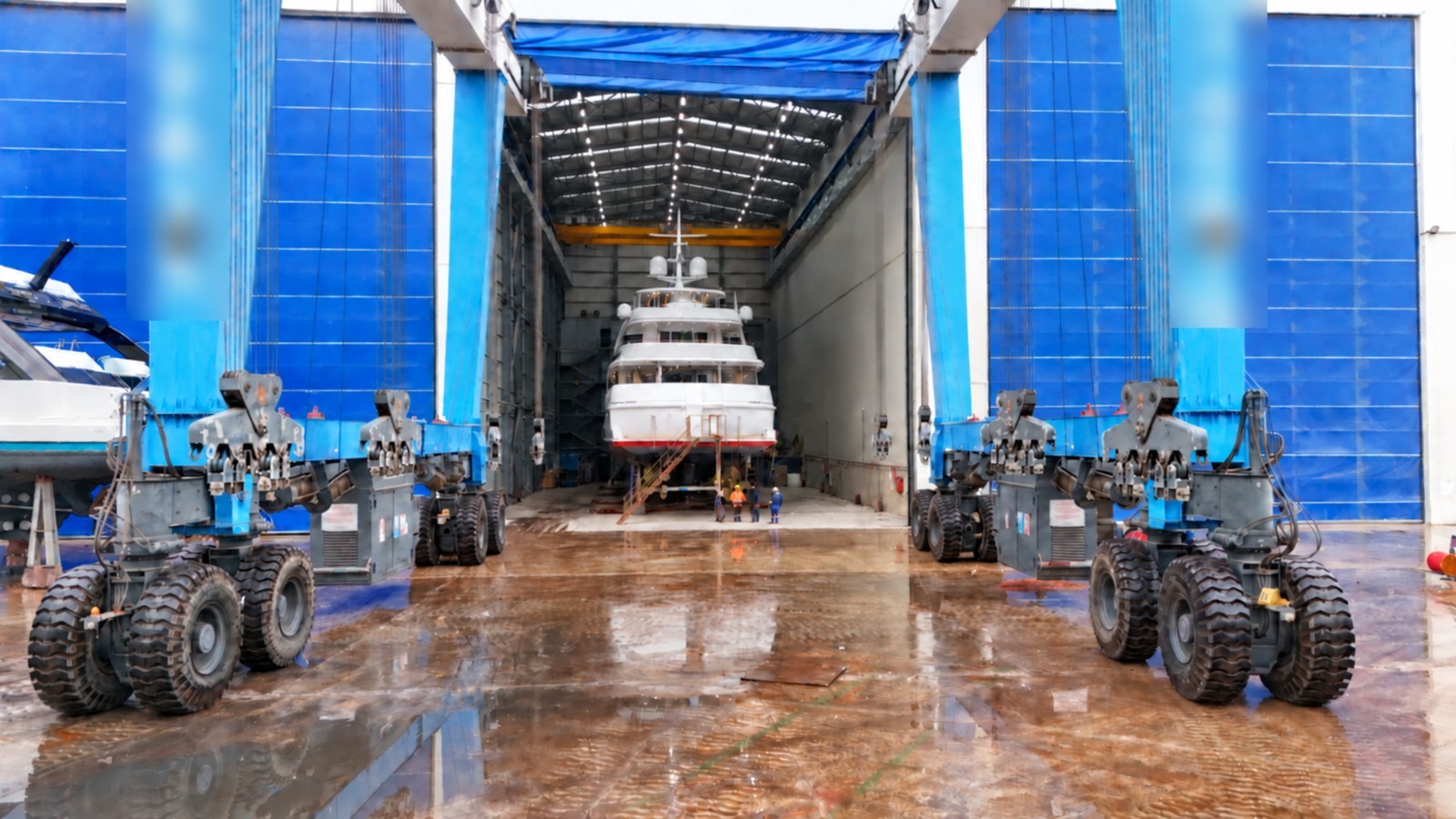 A motor yacht inside the covered hall during a yard period