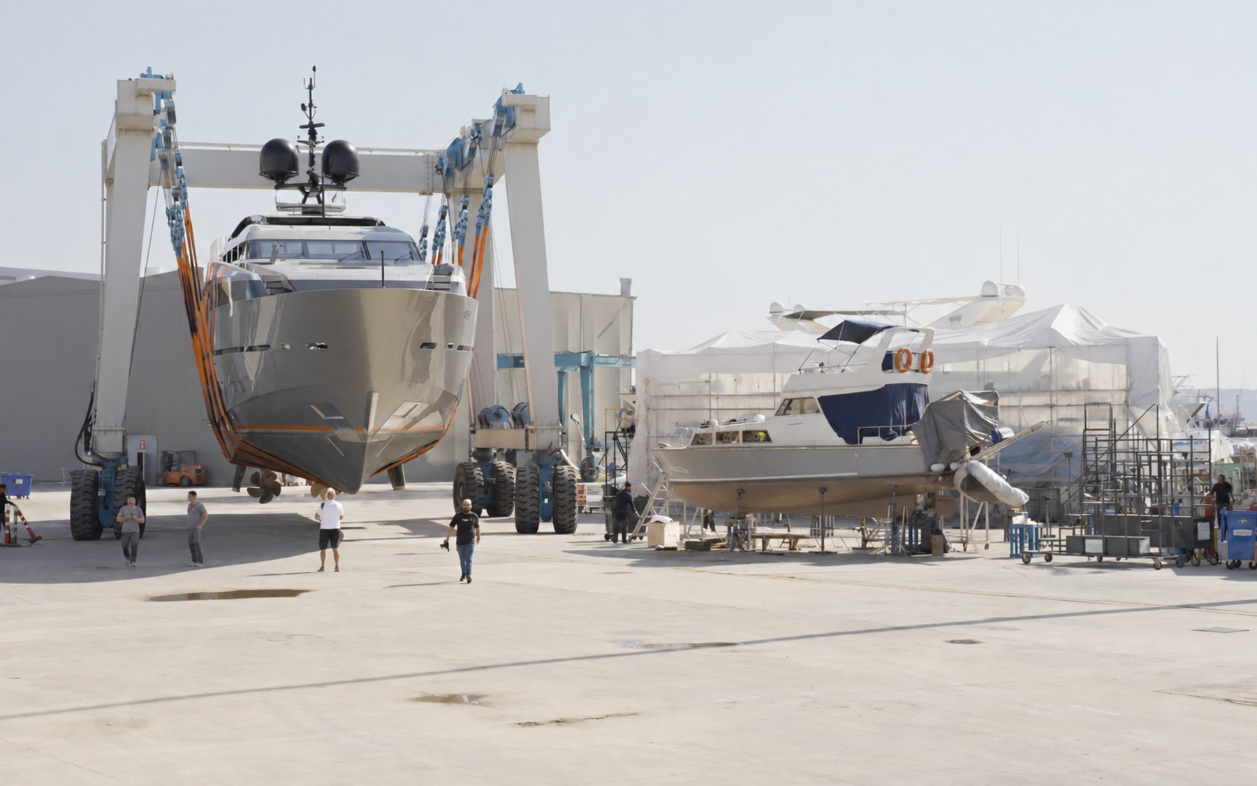 Travel lift and a second yacht ashore in an active yard