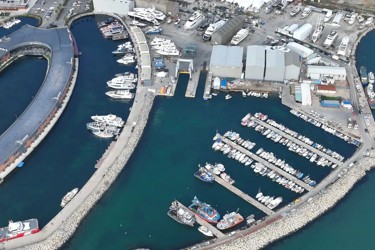 Aerial view of the marina basin, covered yard buildings and yachts on the hardstanding