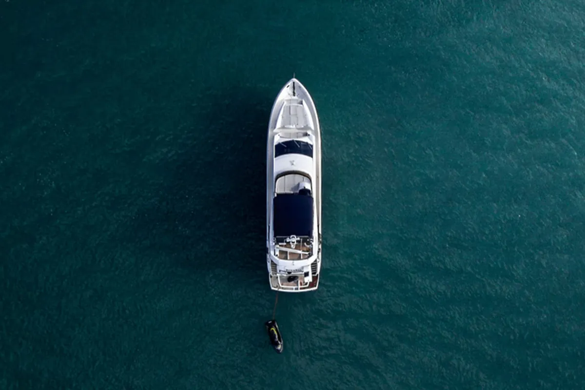 Motor yacht and tender seen directly from above in open water