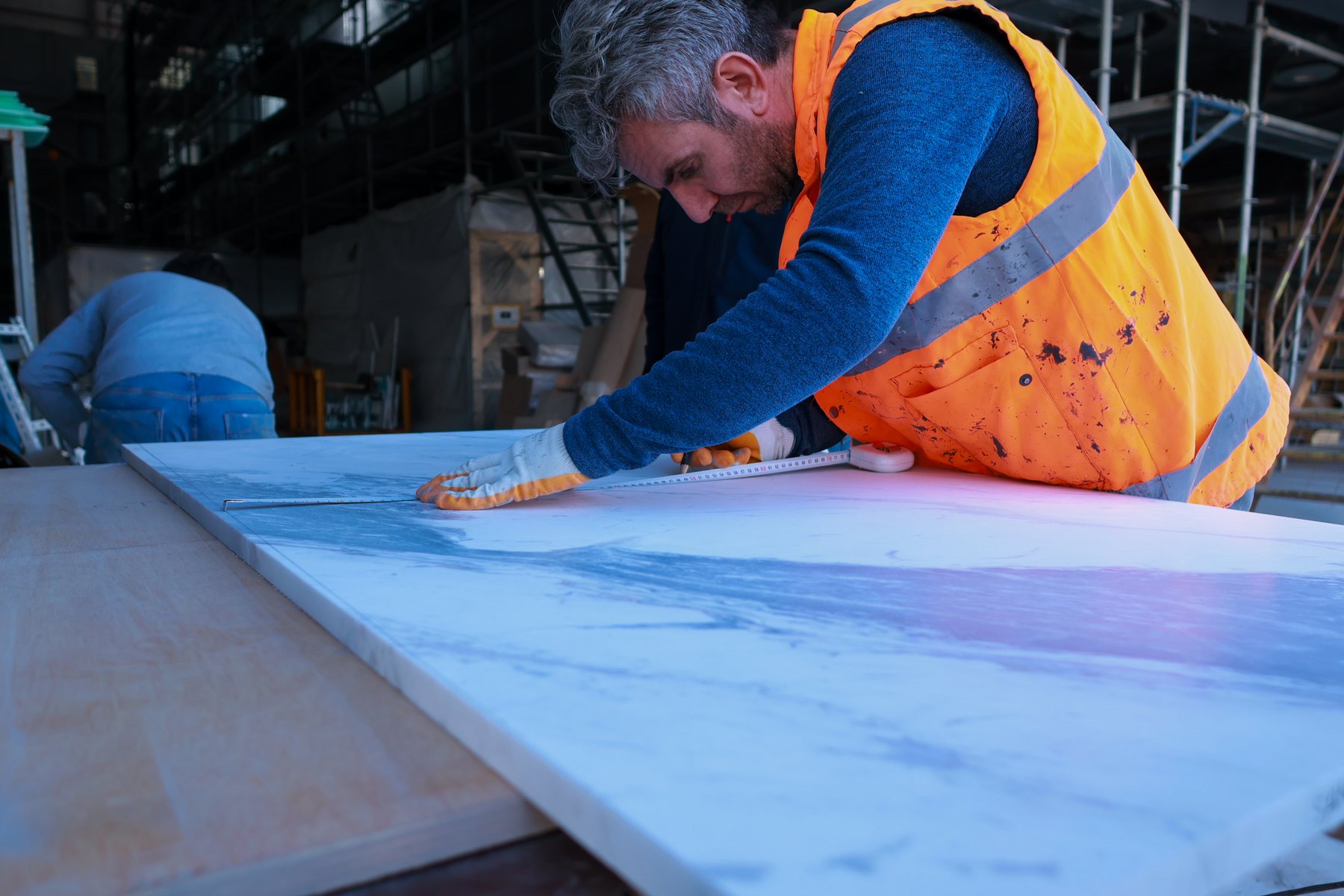 Yard specialist measuring a panel during preparation work