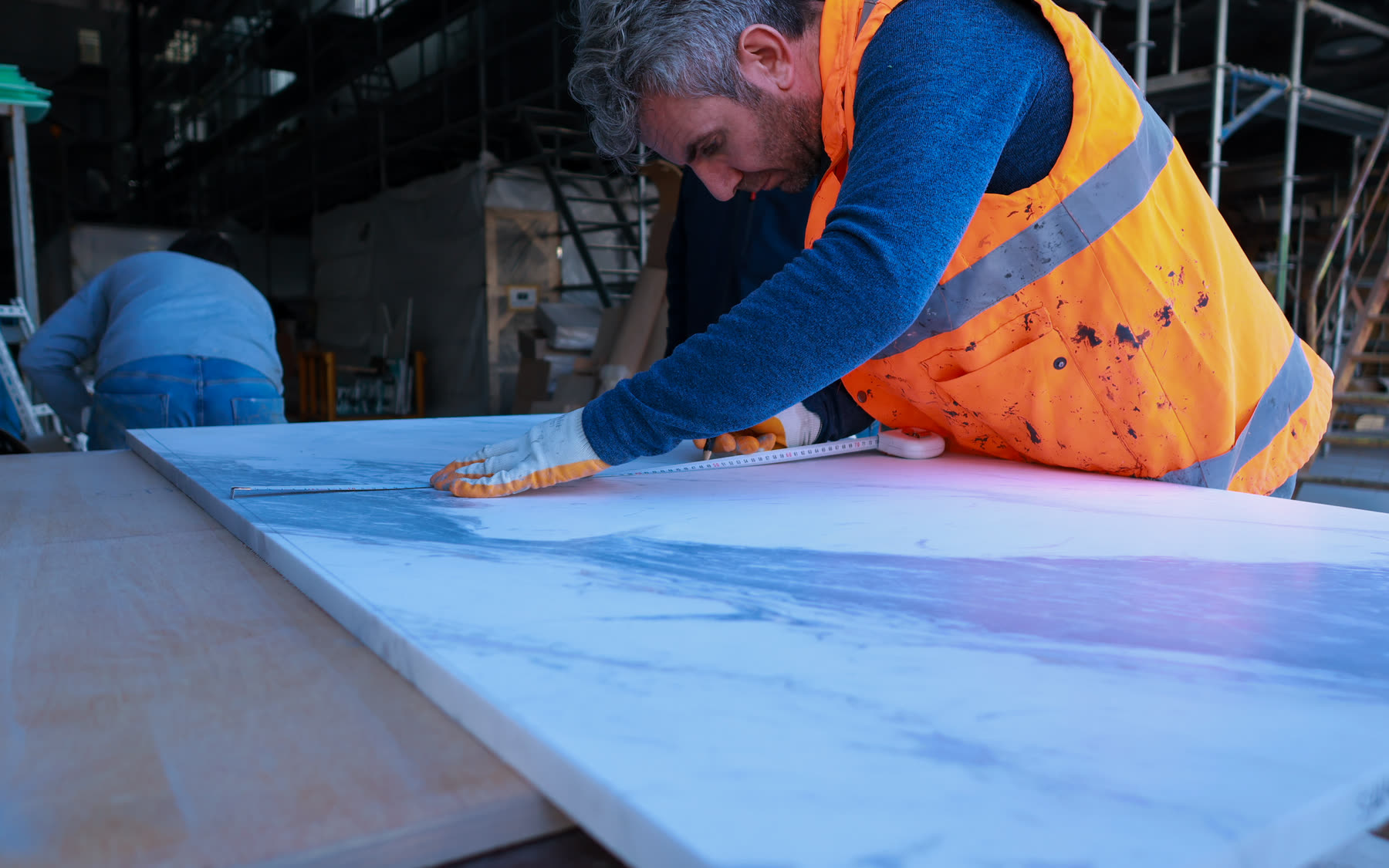 Yard specialist measuring a panel for a line item