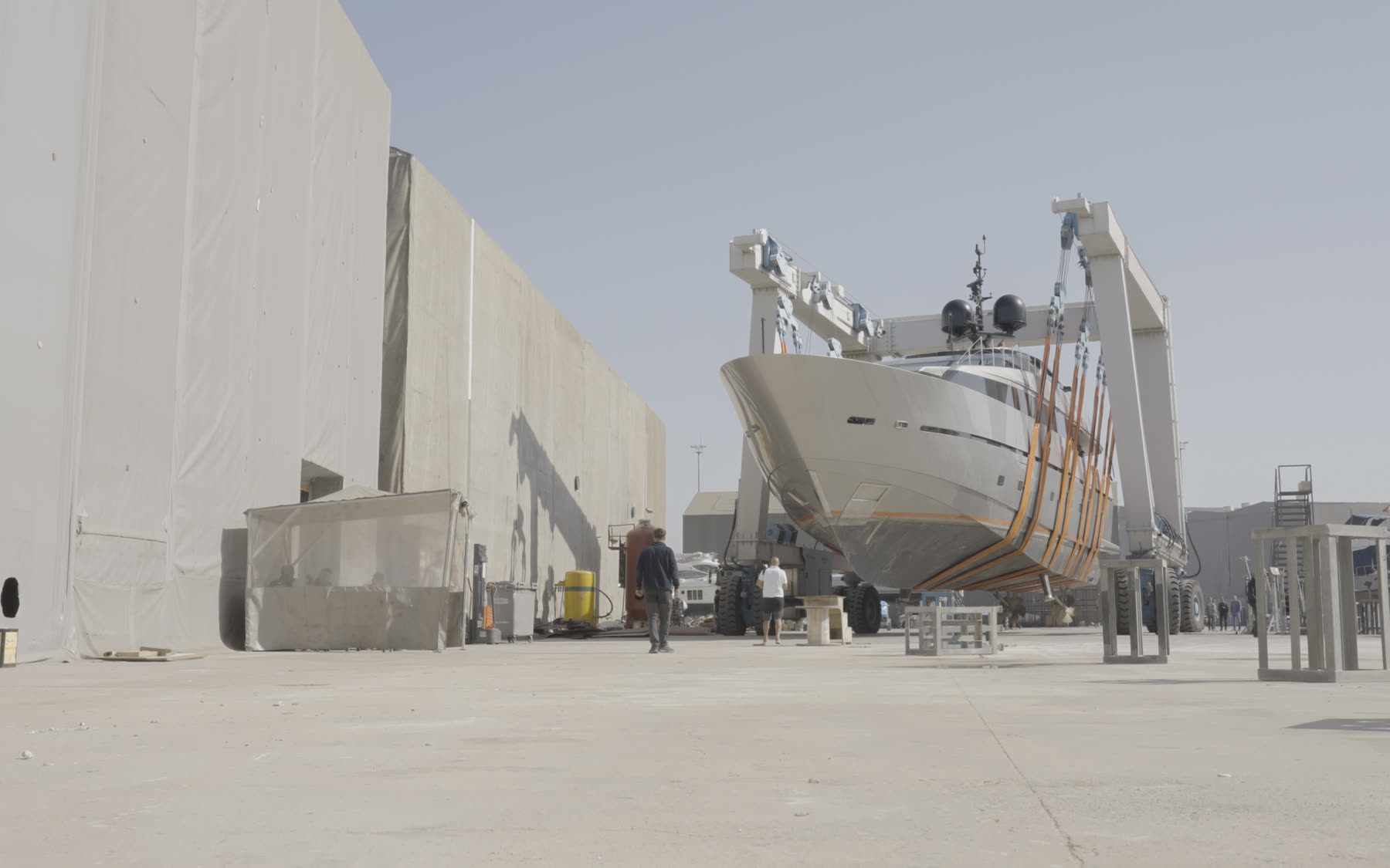 Yacht being moved on a travel lift across the yard